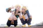 blonde_hair blouse blue_eyes cosplay crossplay detached_sleeves hairbow hair_clips headset kagamine_len kagamine_rin leggings mogeta scarf_tie shorts uri vocaloid rating:Safe score:0 user:pixymisa