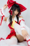 cosplay croptop detached_sleeves hairbow hakurei_reimu lenfried miko pleated_skirt skirt thighhighs touhou rating:Questionable score:5 user:nil!