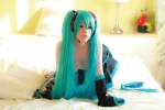 aqua_hair arai_yomi bed cleavage cosplay detached_sleeves hatsune_miku headset pleated_skirt skirt thighhighs twintails vocaloid rating:Safe score:1 user:nil!