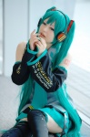 aqua_hair beng cosplay default_costume detached_sleeves hatsune_miku headset pleated_skirt skirt thighhighs tie twintails vocaloid zettai_ryouiki rating:Safe score:1 user:nil!