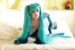 aqua_hair arai_yomi bed blouse cleavage cosplay detached_sleeves hatsune_miku headset open_clothes pleated_skirt skirt thighhighs tie twintails vocaloid rating:Safe score:0 user:nil!