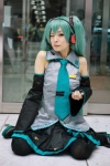 aqua_hair blouse cosplay detached_sleeves hatsune_miku headset maitako pleated_skirt skirt thighhighs tie twintails vocaloid rating:Safe score:2 user:pixymisa