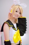 blonde_hair cosplay default_costume detached_sleeves hairbow hair_clips headset kagamine_rin nepachi sailor_uniform school_uniform shorts vocaloid rating:Safe score:0 user:nil!