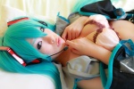 aqua_hair arai_yomi bed blouse bra cleavage cosplay detached_sleeves hatsune_miku headset open_clothes pleated_skirt skirt tie twintails vocaloid rating:Safe score:1 user:nil!