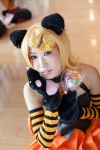 animal_ears blonde_hair cat_ears cat_paws cosplay detached_sleeves hair_clips halter_top kagamine_rin paw_gloves pleated_skirt skirt striped tomoshibi vocaloid rating:Safe score:0 user:pixymisa