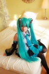 aqua_hair arai_yomi bed blouse cosplay detached_sleeves hatsune_miku headset pleated_skirt skirt thighhighs tie twintails vocaloid rating:Safe score:0 user:nil!