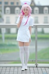 cosplay guilty_crown hair_ties hiiragi_haruka nurse nurse_cap nurse_uniform pink_hair thighhighs twintails yuzuriha_inori zettai_ryouiki rating:Safe score:3 user:pixymisa