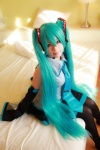 aqua_hair arai_yomi bed blouse cosplay detached_sleeves hatsune_miku headset pleated_skirt skirt thighhighs tie twintails vocaloid rating:Safe score:1 user:nil!