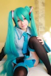 aqua_hair arai_yomi bed blouse cosplay detached_sleeves hatsune_miku headset pleated_skirt skirt thighhighs tie twintails vocaloid zettai_ryouiki rating:Safe score:1 user:nil!