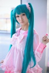 aqua_eyes aqua_hair bow cosplay dress hatsune_miku lollipop seri tiered_skirt twintails vocaloid rating:Safe score:0 user:pixymisa