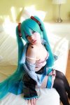 aqua_hair arai_yomi bed blouse bra cleavage cosplay detached_sleeves hatsune_miku headset open_clothes panties pleated_skirt skirt thighhighs tie twintails underboob vocaloid rating:Safe score:2 user:nil!