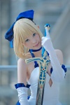 ageha blonde_hair blue_eyes choker cosplay dress elbow_gloves fate/series fate/stay_night gloves hairbow pointed_skirt saber skirt_train sword rating:Safe score:1 user:pixymisa