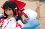 ass barefoot beach cosplay detached_sleeves hairbow hakurei_reimu lenfried miko one-piece_swimsuit swimsuit touhou rating:Safe score:1 user:nil!