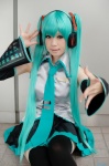 aqua_hair cosplay default_costume detached_sleeves hatsune_miku headset pleated_skirt skirt thighhighs tie twintails vocaloid zettai_ryouiki rating:Safe score:0 user:nil!