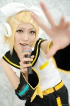 blonde_hair cosplay default_costume detached_sleeves hairbow headset kagamine_rin microphone shorts vocaloid yuuhi rating:Safe score:1 user:nil!