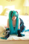 aqua_hair arai_yomi bed cleavage cosplay detached_sleeves hatsune_miku headset pleated_skirt skirt thighhighs twintails vocaloid rating:Safe score:1 user:nil!