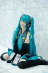 aqua_hair blouse cosplay detached_sleeves hatsune_miku headset kei pleated_skirt skirt thighhighs tie twintails vocaloid zettai_ryouiki rating:Safe score:1 user:nil!