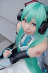 apron aqua_hair cosplay detached_sleeves hatsune_miku headset mizuhara_akio pleated_skirt skirt sweater_vest tagme_song tie twintails vocaloid whisk rating:Safe score:1 user:nil!