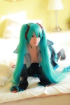 aqua_hair arai_yomi bed blouse cleavage cosplay detached_sleeves hatsune_miku headset open_clothes pleated_skirt skirt thighhighs tie twintails vocaloid rating:Safe score:0 user:nil!