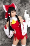 cosplay detached_sleeves hairbow hakurei_reimu lenfried miko one-piece_swimsuit swimsuit thighhighs touhou rating:Safe score:1 user:nil!