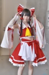 cosplay croptop detached_sleeves hairbow hakurei_reimu miko miniskirt popuri skirt touhou rating:Safe score:3 user:nil!