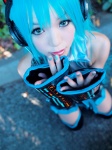 aqua_hair cosplay default_costume detached_sleeves hatsune_miku headset kipi pleated_skirt skirt thighhighs tie twintails vocaloid zettai_ryouiki rating:Safe score:3 user:nil!