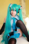 aqua_hair arai_yomi bed blouse cosplay detached_sleeves hatsune_miku headset pleated_skirt skirt thighhighs tie twintails vocaloid zettai_ryouiki rating:Safe score:0 user:nil!