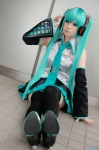 aqua_hair cosplay default_costume detached_sleeves hatsune_miku headset pleated_skirt skirt thighhighs tie twintails vocaloid zettai_ryouiki rating:Safe score:1 user:nil!