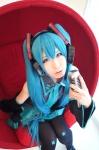 black_legwear blouse blue_hair cosplay detached_sleeves haruka hatsune_miku headset microphone pleated_skirt skirt sleeveless_blouse thighhighs twintails vocaloid rating:Safe score:0 user:nil!