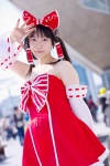 androp bow cosplay detached_sleeves dress hairbow hakurei_reimu quad_tails touhou rating:Safe score:0 user:pixymisa