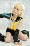 blonde_hair cosplay default_costume detached_sleeves hairbow headset kagamine_rin leg_warmers shorts vocaloid yuuhi rating:Safe score:0 user:nil!