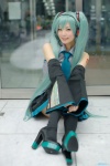 aqua_hair blouse cosplay detached_sleeves hatsune_miku headset maitako pleated_skirt skirt thighhighs tie twintails vocaloid rating:Safe score:2 user:pixymisa