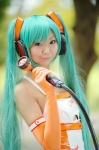 aqua_hair cosplay elbow_gloves gloves hatsune_miku headset jumper_shorts necoco twintails vocaloid rating:Safe score:2 user:nil!