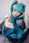 aiko aqua_hair cosplay default_costume detached_sleeves hatsune_miku headset pleated_skirt skirt thighhighs tie twintails vocaloid zettai_ryouiki rating:Safe score:1 user:nil!
