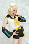 blonde_hair cosplay default_costume detached_sleeves hairbow headset kagamine_rin microphone shorts vocaloid yuuhi rating:Safe score:0 user:nil!