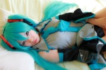 aqua_hair arai_yomi bed blouse cosplay detached_sleeves hatsune_miku headset pleated_skirt skirt tie twintails vocaloid rating:Safe score:0 user:nil!