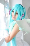 aqua_hair cosplay dress elbow_gloves gloves hatsune_miku head_wings madoka_chami project_diva_2nd twintails vocaloid wings rating:Safe score:1 user:xkaras