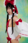 ass cosplay detached_sleeves hairbow hakurei_reimu lenfried miko one-piece_swimsuit swimsuit touhou rating:Safe score:0 user:nil!