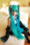 aqua_hair arai_yomi bed blouse cosplay detached_sleeves hatsune_miku headset pleated_skirt skirt thighhighs tie twintails vocaloid rating:Safe score:0 user:nil!