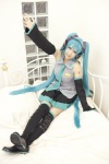 aqua_hair bed blouse cosplay detached_sleeves hatsune_miku headset pleated_skirt rito_akira skirt thighhighs tie twintails vocaloid zettai_ryouiki rating:Safe score:1 user:nil!