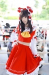 blouse cosplay detached_sleeves hairbow hakurei_reimu miko skirt skirt_lift touhou you_(ii) rating:Safe score:0 user:nil!