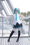 aqua_hair black_legwear cosplay glasses hatsune_miku headset pleated_skirt popuri skirt sleeveless_blouse thighhighs tie twintails vocaloid zettai_ryouiki rating:Safe score:2 user:nil!