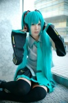 aqua_hair cosplay default_costume detached_sleeves hatsune_miku headset narihara_riku pleated_skirt skirt thighhighs tie twintails vocaloid zettai_ryouiki rating:Safe score:0 user:nil!