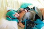 aqua_hair arai_yomi bed blouse bra cleavage cosplay detached_sleeves hatsune_miku headset open_clothes pleated_skirt skirt tie twintails vocaloid rating:Safe score:0 user:nil!