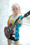 cosplay guitar harumiya_yun headphones miniskirt necklace nitro_super_sonic pantyhose pink_hair sheer_legwear skirt super_soniko track_jacket tshirt rating:Safe score:0 user:pixymisa