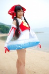 beach cosplay detached_sleeves hairbow hakurei_reimu lenfried ocean one-piece_swimsuit swimsuit touhou rating:Safe score:0 user:nil!