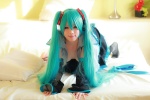 aqua_hair arai_yomi bed blouse cleavage cosplay detached_sleeves hatsune_miku headset open_clothes pleated_skirt skirt thighhighs tie twintails vocaloid rating:Safe score:1 user:nil!