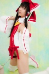 boots cosplay detached_sleeves hairbow hakurei_reimu handcuffs kneepads lenfried miko one-piece_swimsuit swimsuit thighhighs touhou rating:Safe score:1 user:nil!