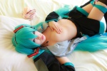 aqua_hair arai_yomi bed blouse cleavage cosplay detached_sleeves hatsune_miku headset open_clothes panties pleated_skirt skirt thighhighs tie twintails vocaloid rating:Safe score:5 user:nil!