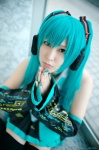 aqua_hair cosplay default_costume detached_sleeves hatsune_miku headset narihara_riku pleated_skirt skirt thighhighs tie twintails vocaloid zettai_ryouiki rating:Safe score:0 user:nil!